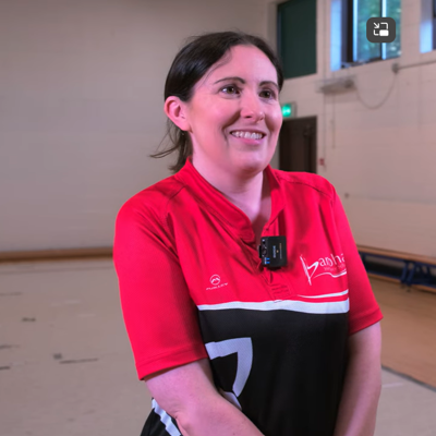 Smiling woman with brown hair in red polo shirt from Banbha Irish Dancing