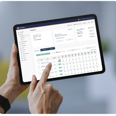 Hand holding a tablet pointing to the ClassForKids Wraparound Care management software