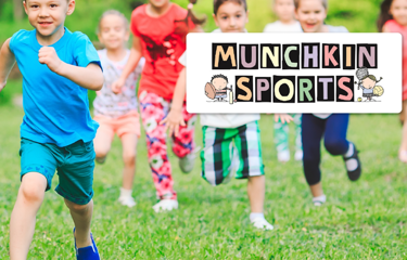 A group of young children run joyfully across a grassy field during a Munchkin Sports session.The children are dressed in bright, colourful clothing, and the Munchkin Sports logo appears in the top right.